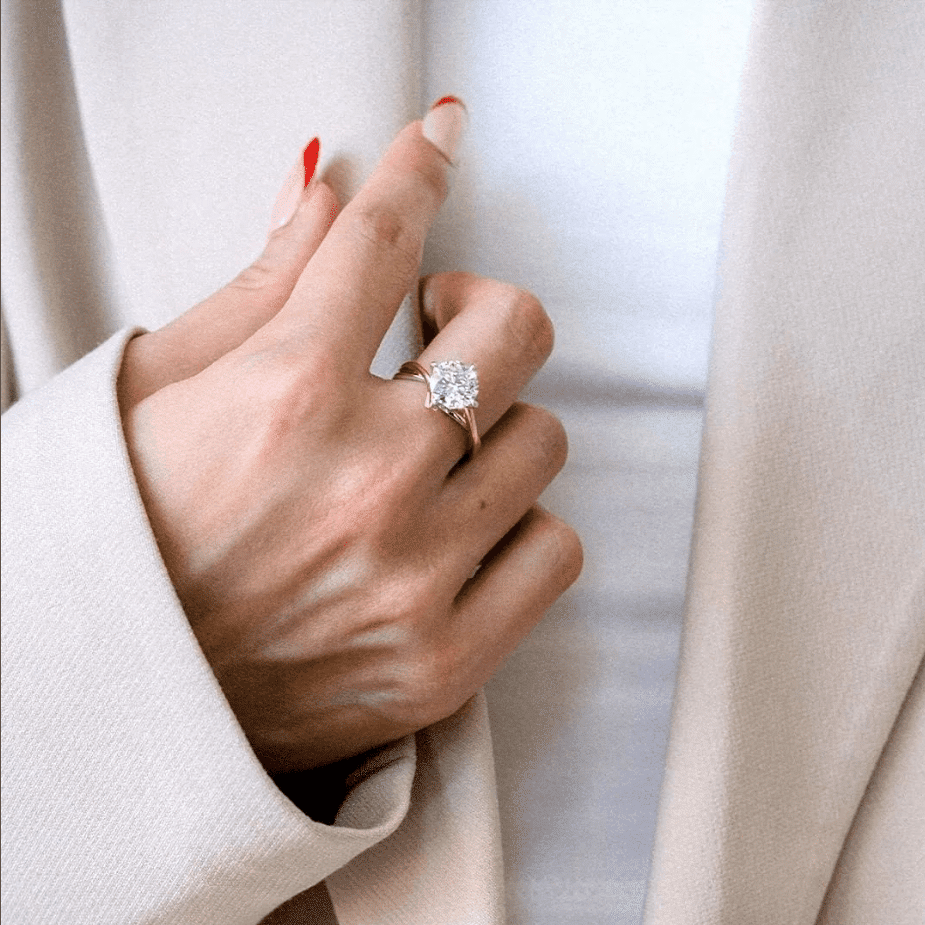 a woman wearing a solitaire engagement ring